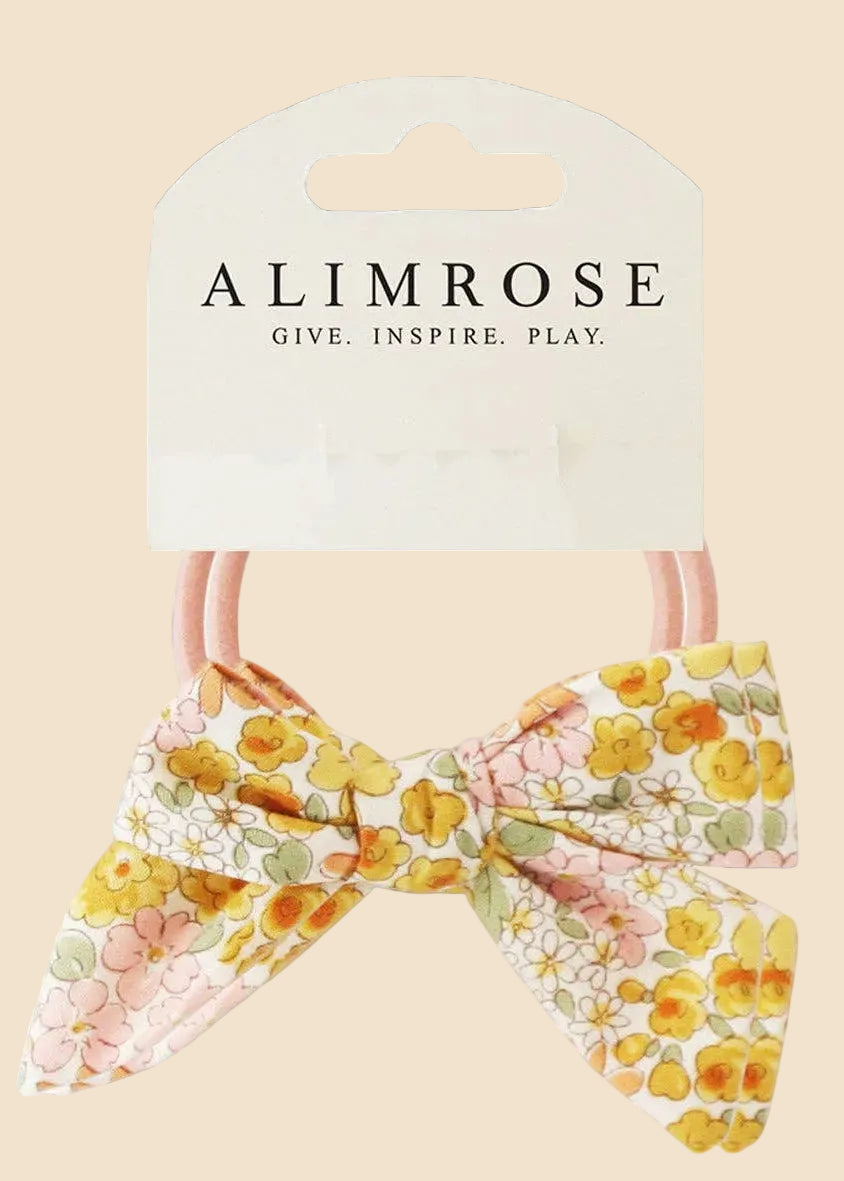Floral bow hair tie with 'Alimrose' packaging on a white background
