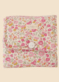 Floral-patterned fabric with a button closure on a white background