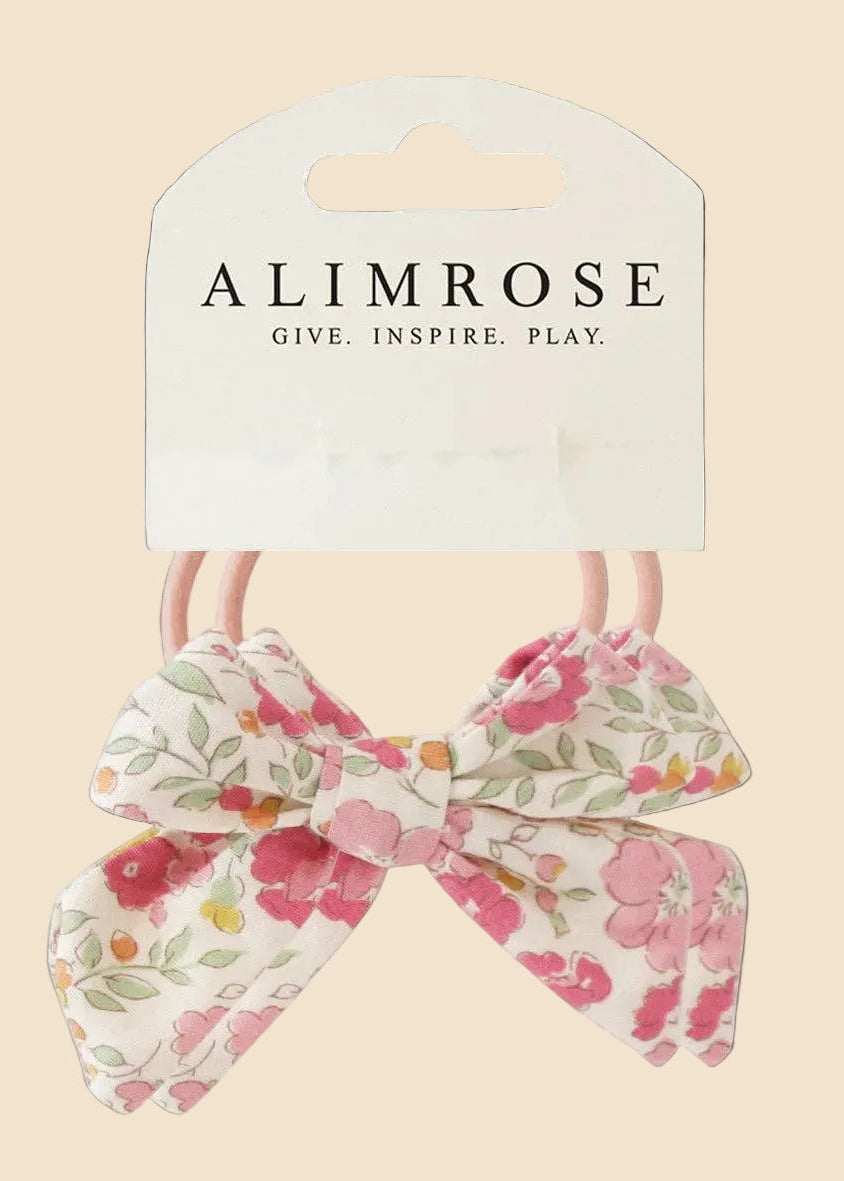 Floral hair bow with packaging displaying 'Alimrose' on a white background