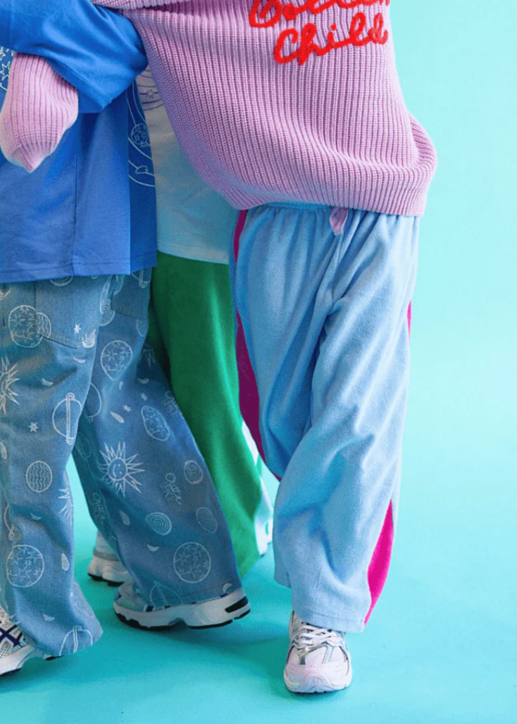 Two people wearing colorful outfits with a blue background