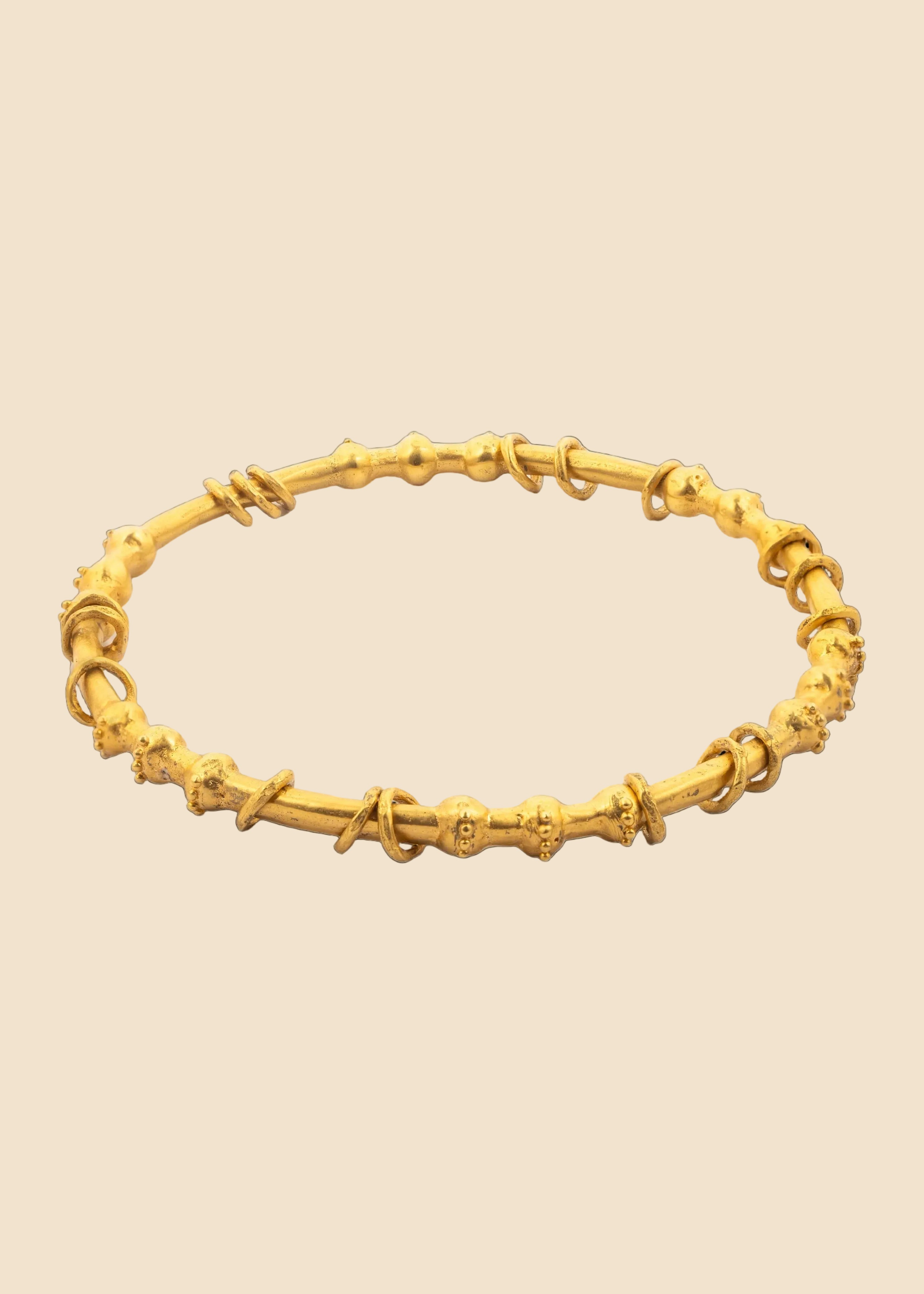 Gold bracelet on a white background