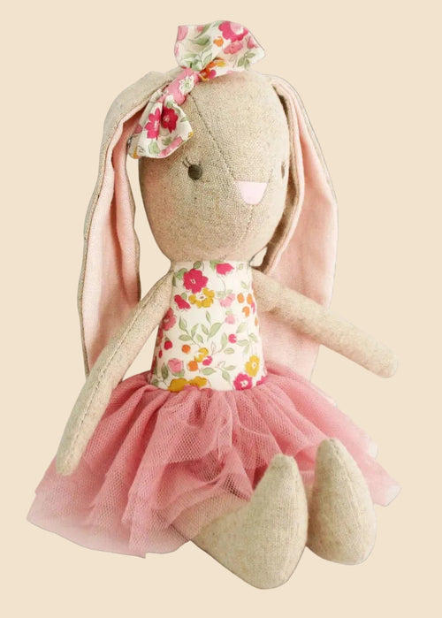 Stuffed bunny toy with a floral dress and pink tutu on a white background