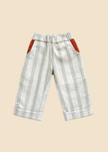 Striped pants with red accents on a light gray background