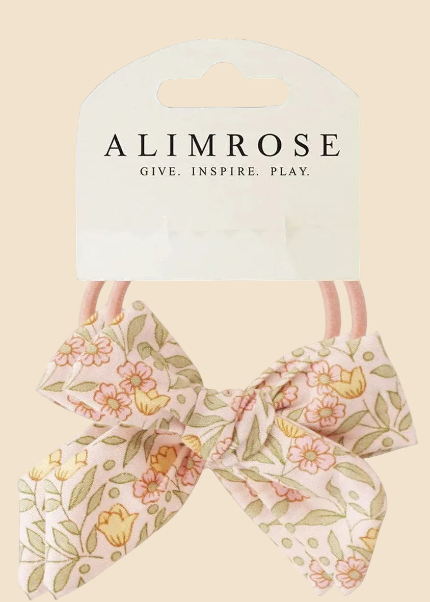 Floral hair bow with packaging displaying 'Alimrose' on a white background