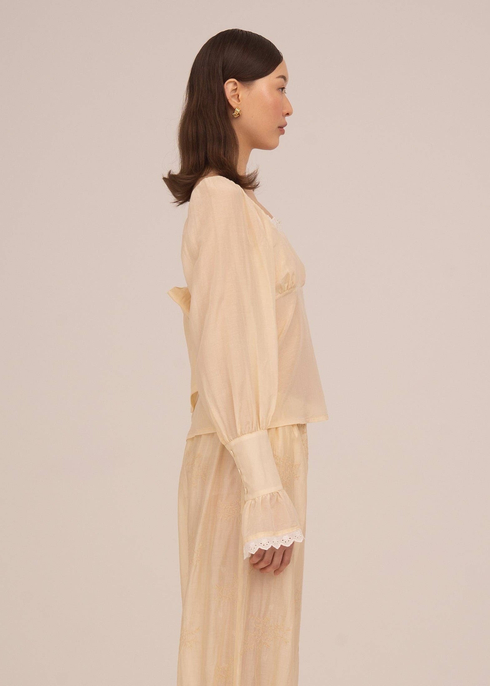 Woman wearing a white outfit on a white background
