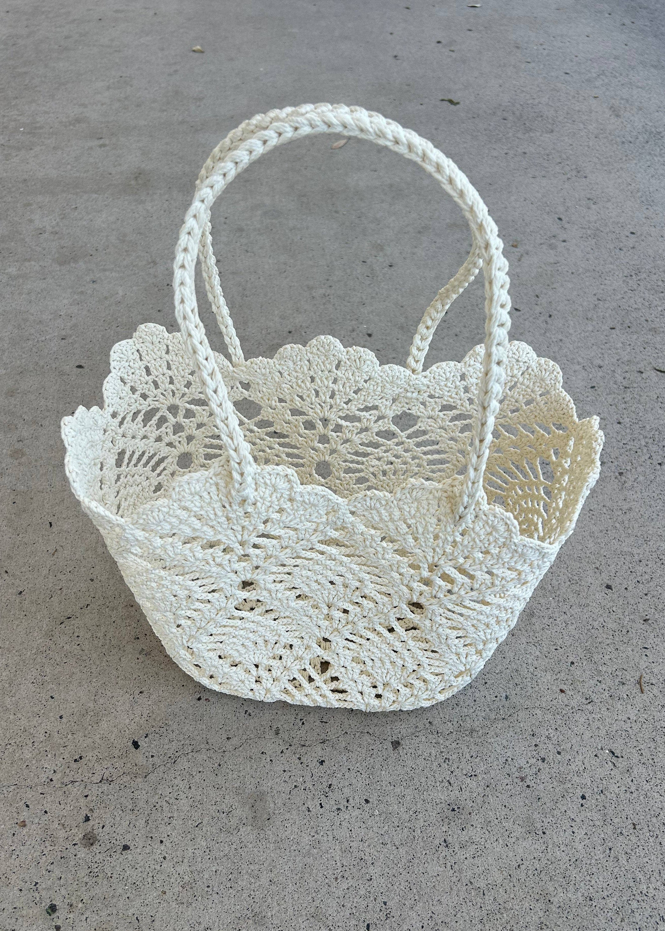 White crochet basket on a concrete surface