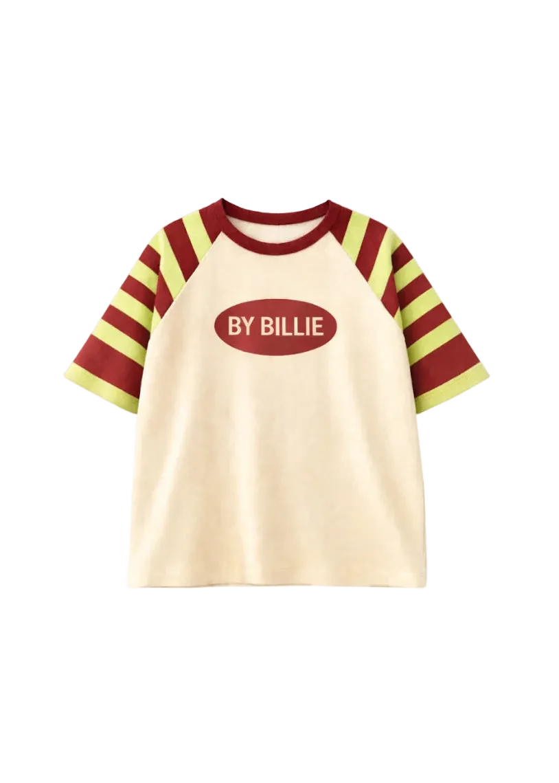 A short-sleeve raglan t-shirt with a cream-colored body, burgundy and lime green striped sleeves, and a central oval graphic that reads 'BY BILLIE' in white text.
