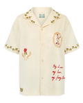 Beige shirt with floral embroidery and text on a white background
