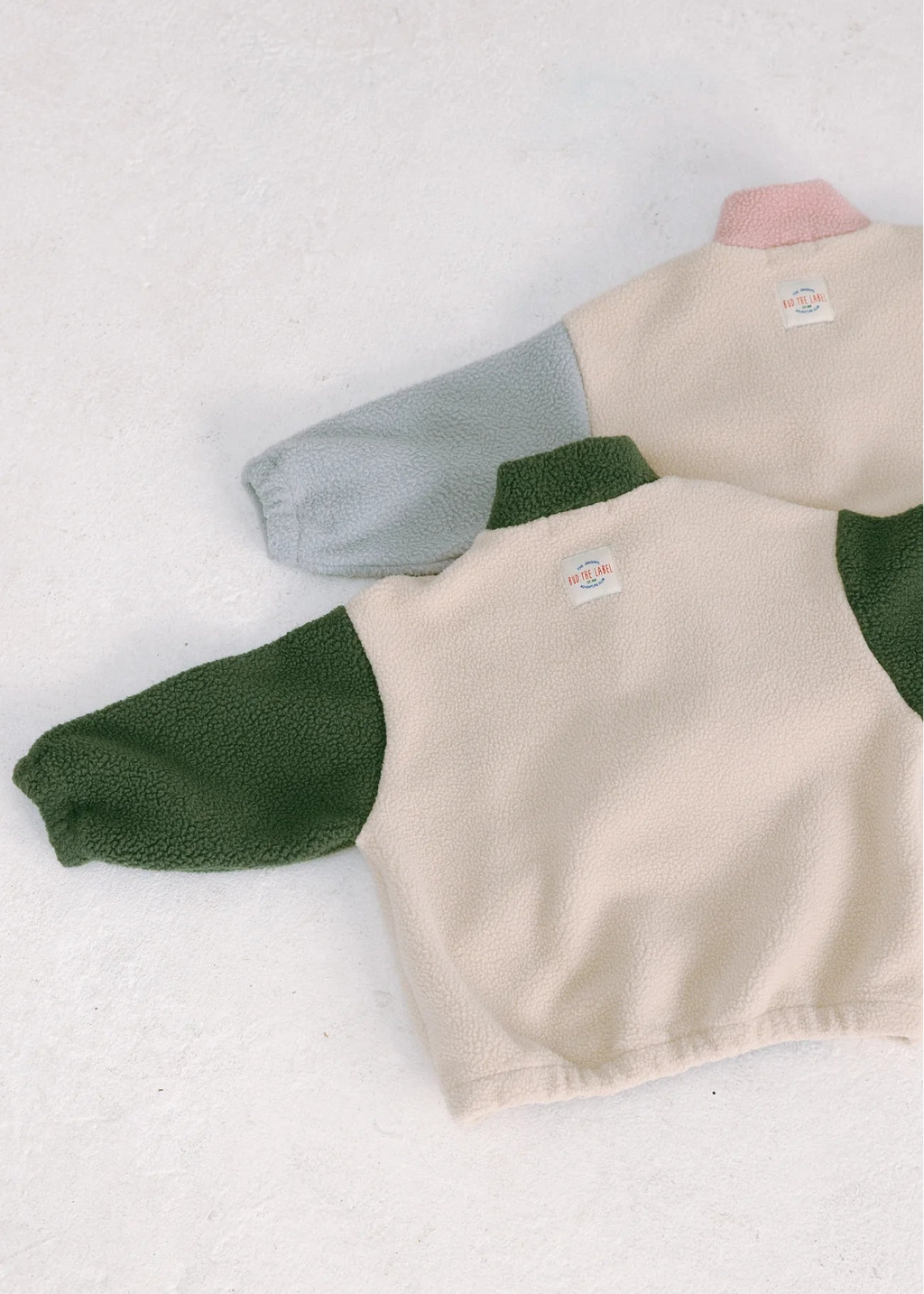 Children's fleece pullover with green sleeves on a white background