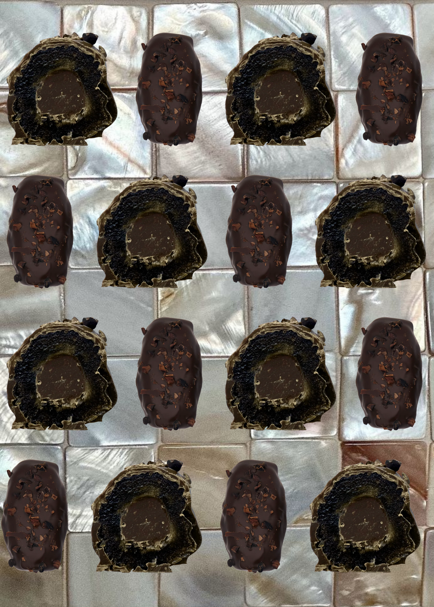 Chocolate truffles arranged in a grid on a reflective surface