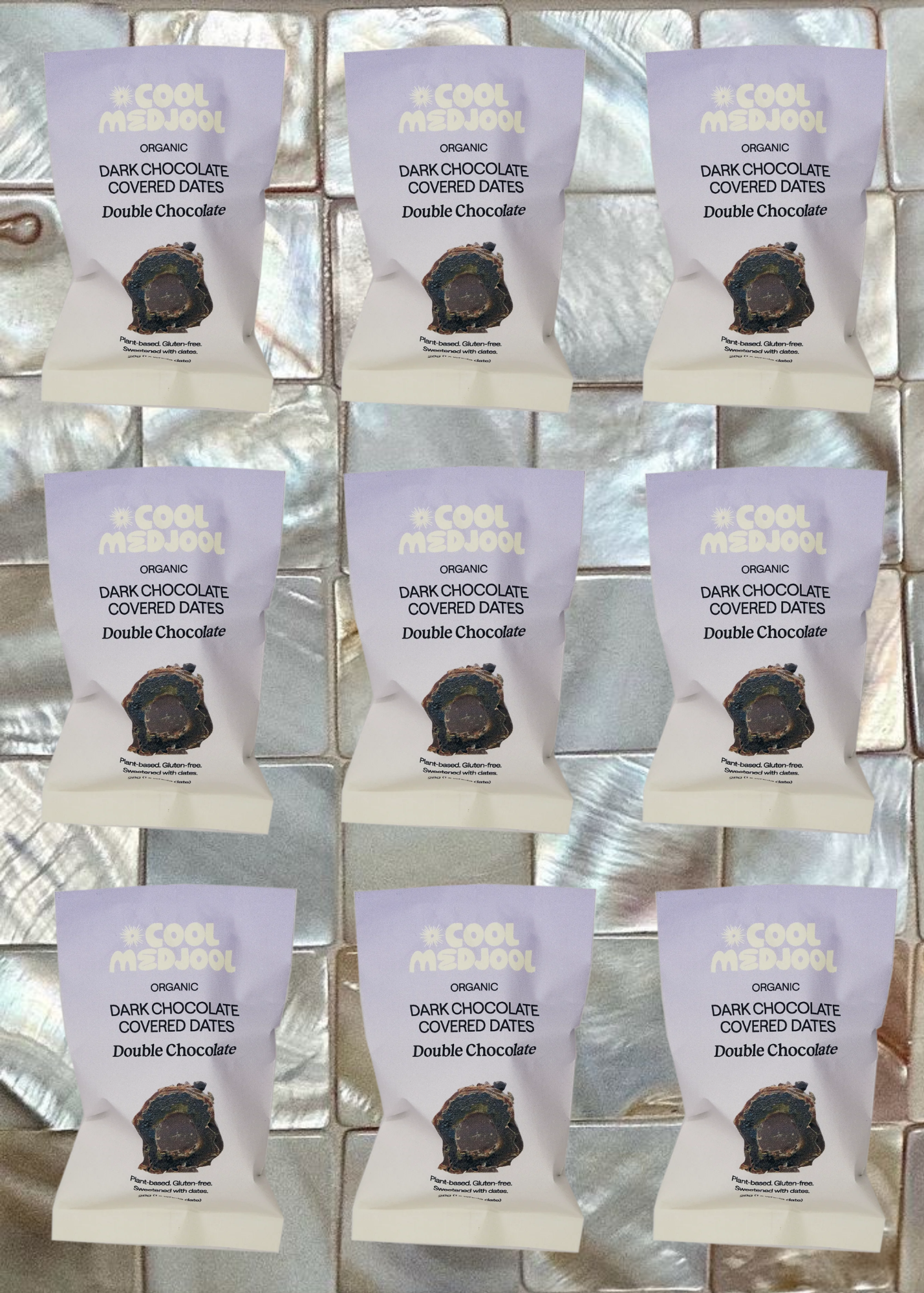 Grid of packages of 'Double Chocolate' dark chocolate covered dates on a reflective surface.