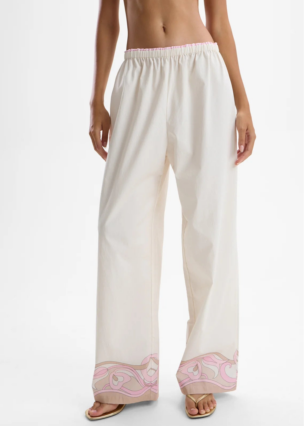 White pants with pink embroidery on a white background