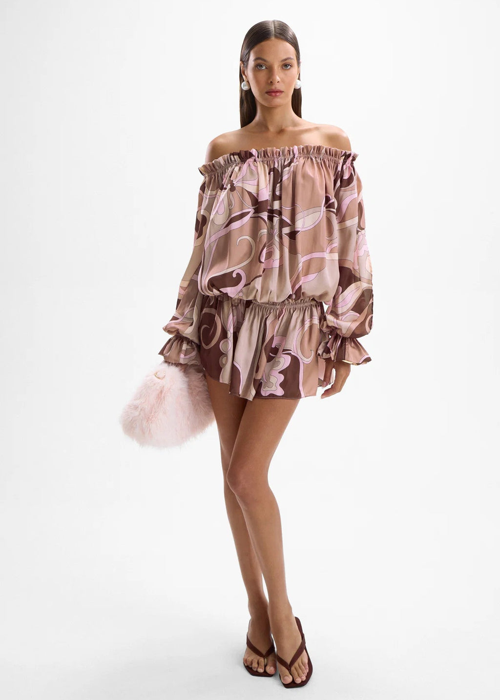 Woman wearing a floral off-shoulder dress on a white background