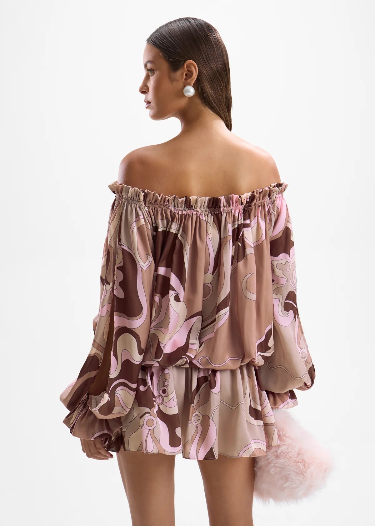 Woman wearing a patterned off-shoulder dress on a white background