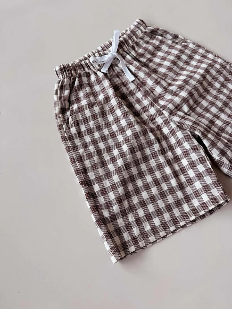 Brown and white checkered shorts on a light gray background