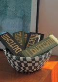 Bowl filled with 'Dutchie' incense cases on a wooden surface
