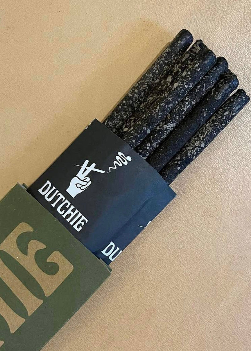 Packaged Dutchie incense products on a beige background
