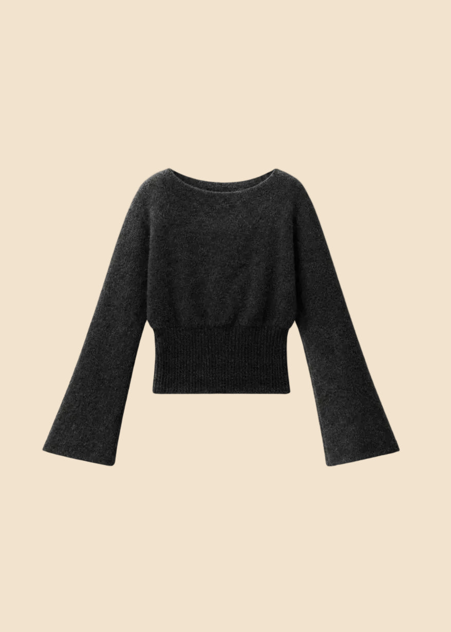 A dark charcoal gray knit sweater with long bell sleeves and a ribbed hem, displayed against a solid beige background.