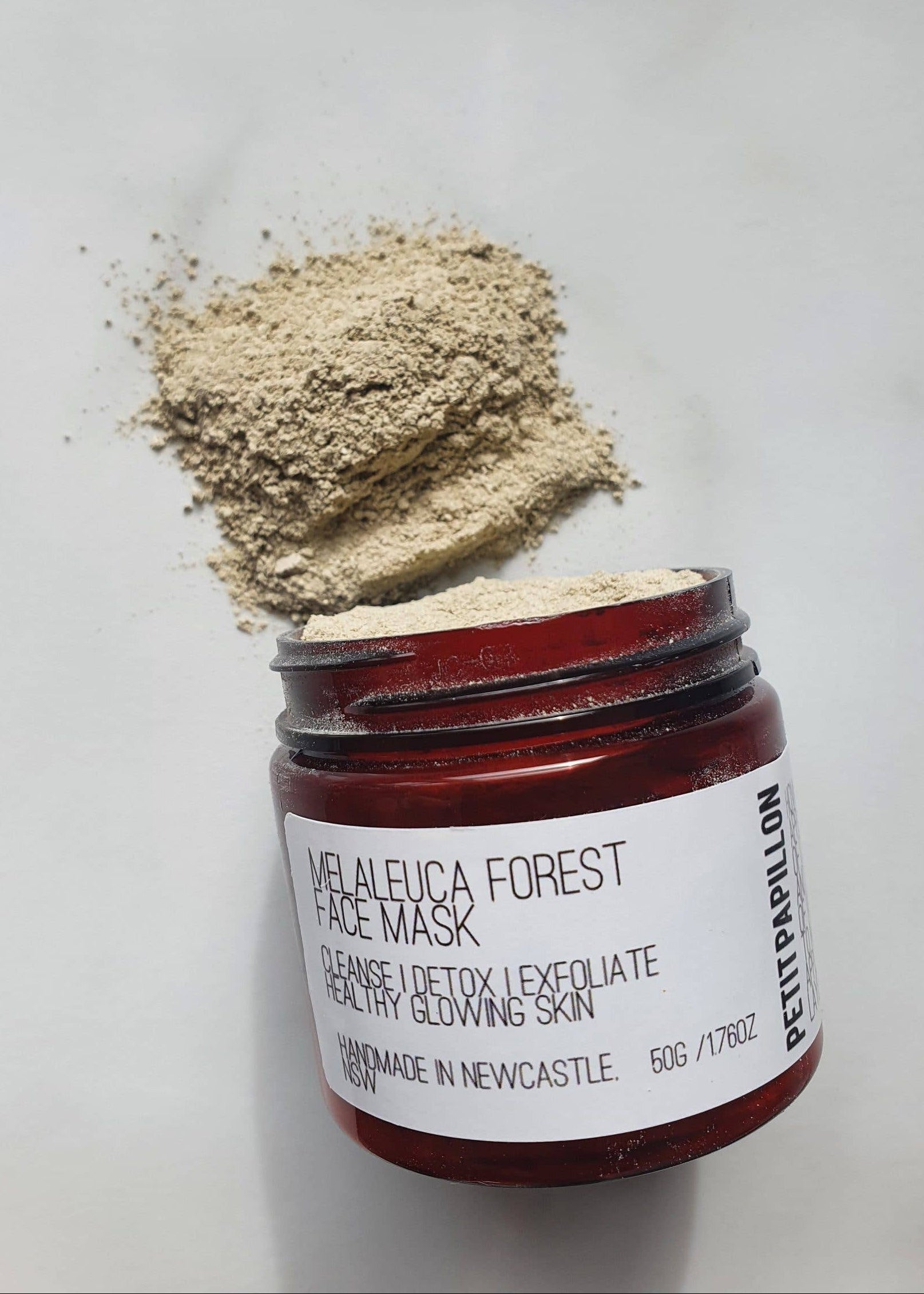 Open jar of Peter Thomas Roth Melaleuca Forest Face Mask with powder on a white background