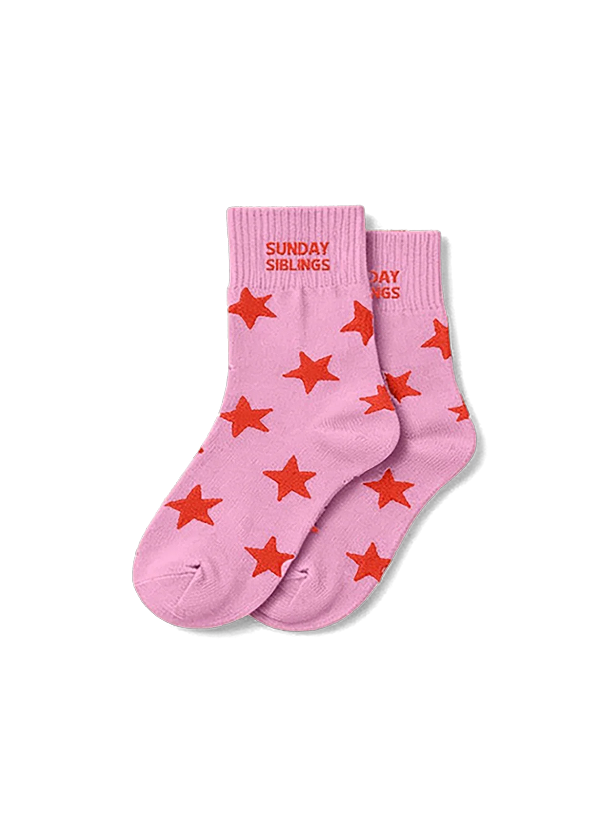 A pair of light pink ankle socks with red star patterns and 'SUNDAY SUNDRIES' printed in red on the cuff, displayed on a clean white background.