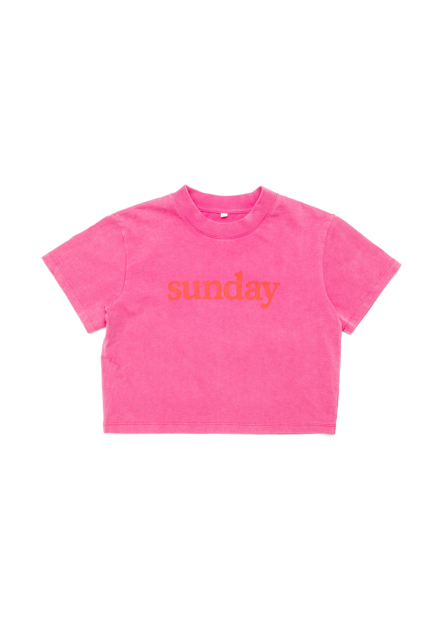 A bright pink short-sleeve crop top t-shirt with the word 'sunday' printed in orange across the chest, displayed flat against a white background.