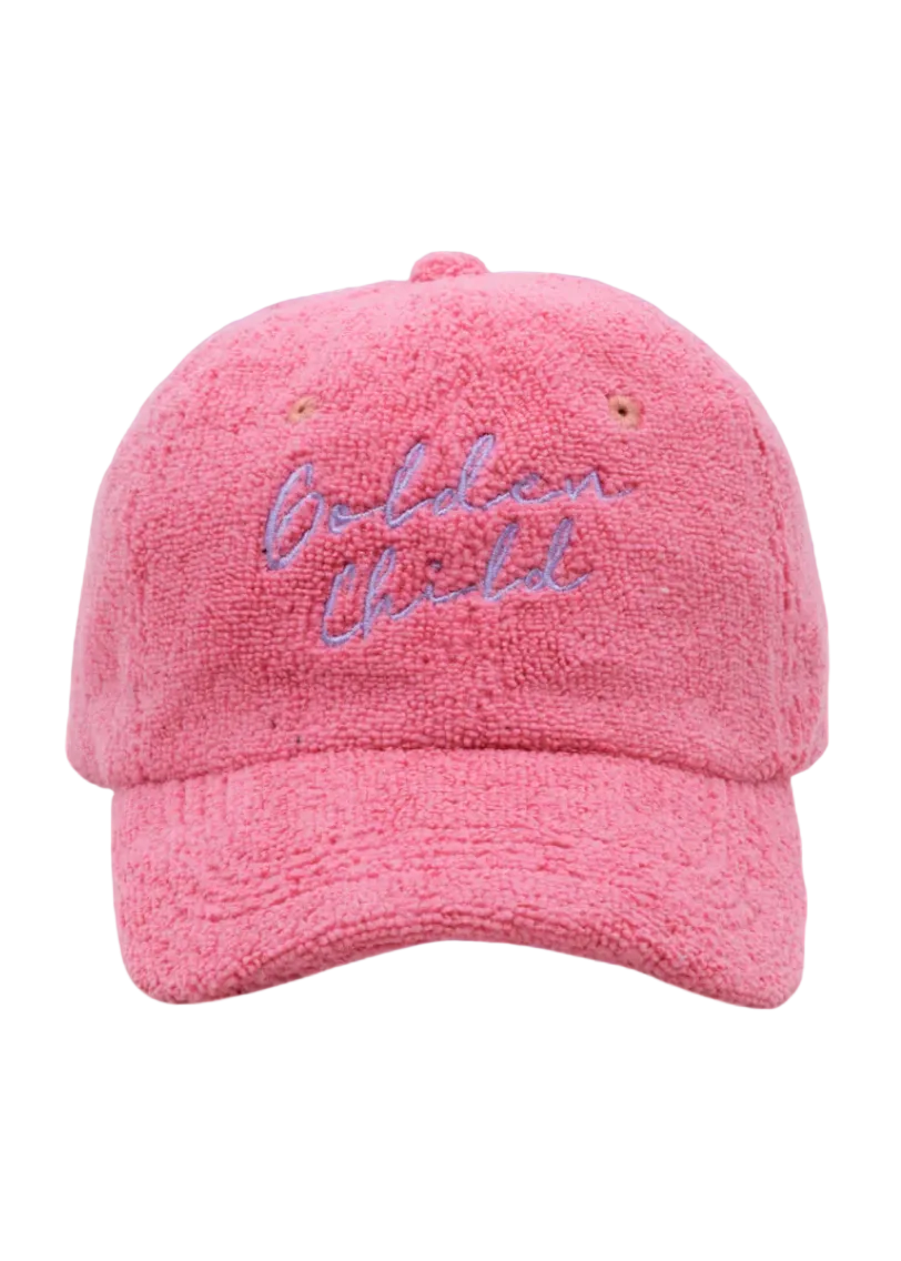 Pink cap with 'Golden Child' embroidery on a blue background