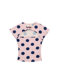 Pink top with blue polka dots on a white background