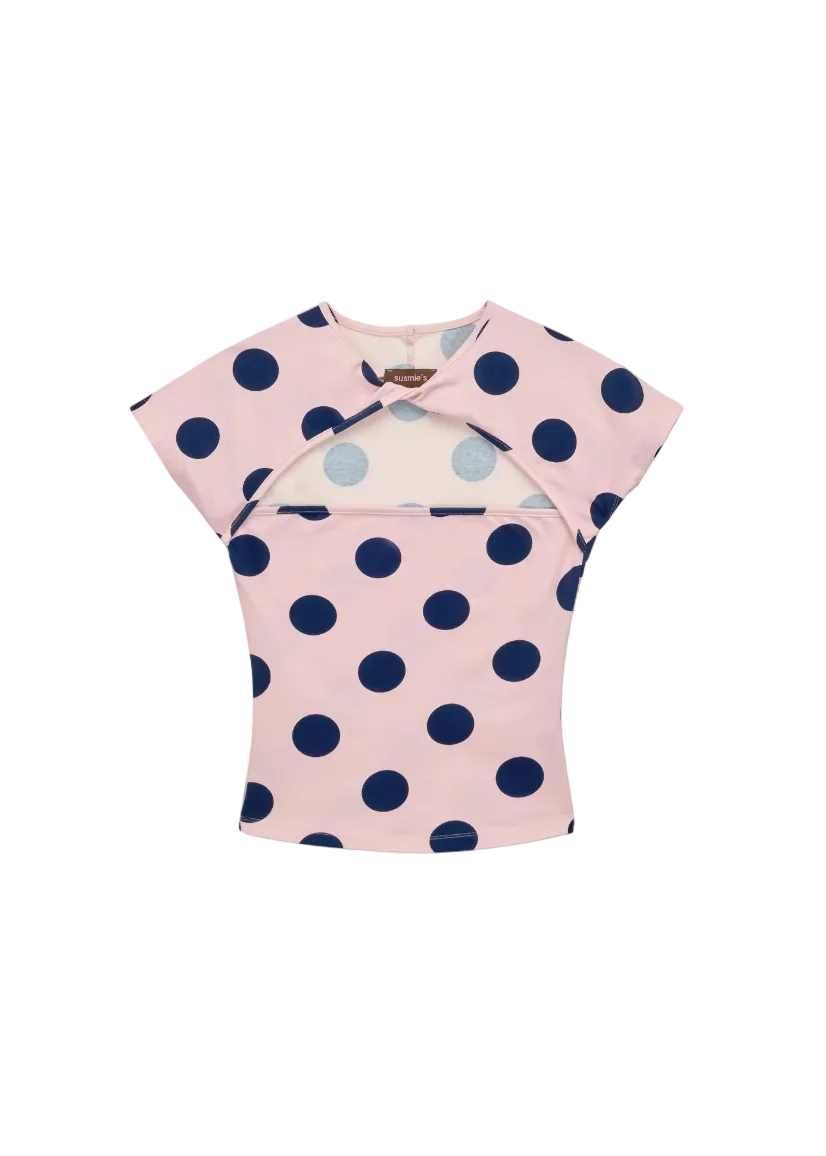 Pink top with blue polka dots on a white background