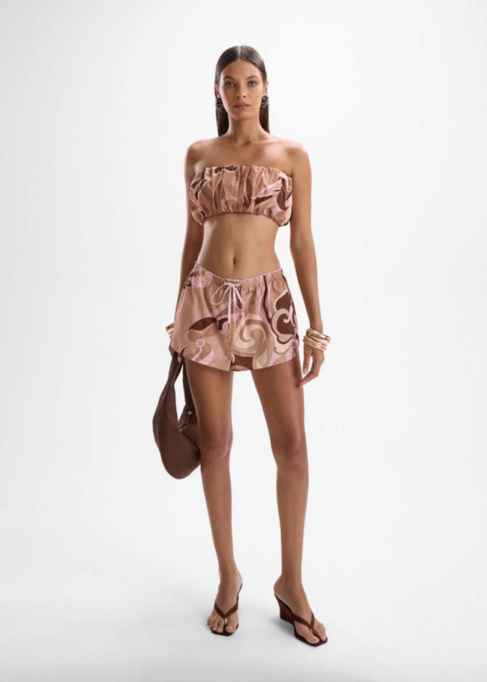 Woman wearing a floral two-piece outfit on a white background