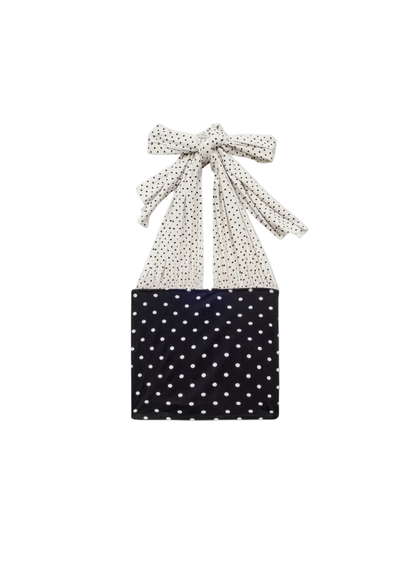 Black top with white polka dots and matching headscarf on a white background