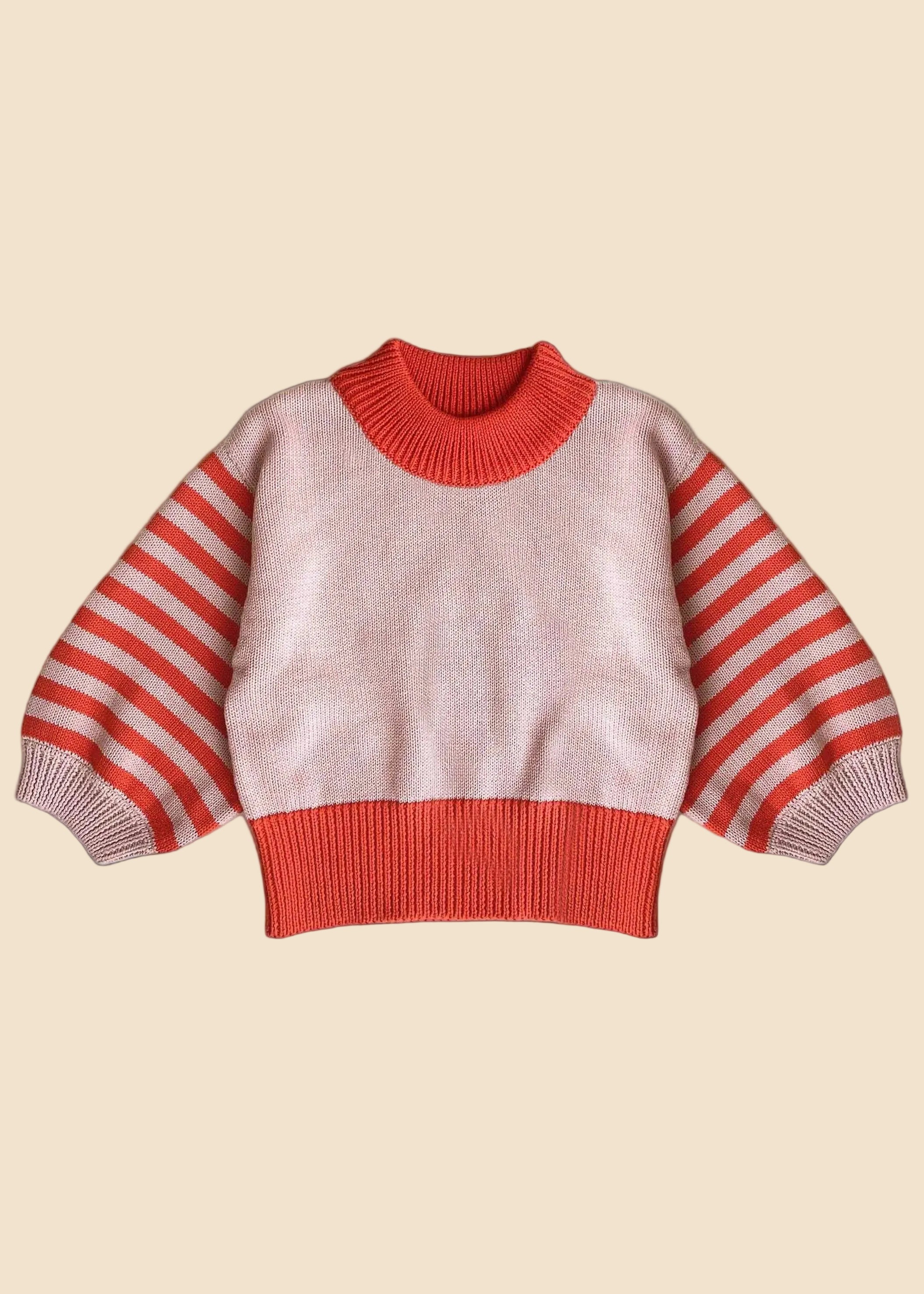 Pink and red striped sweater on a white background
