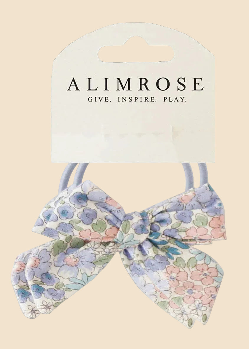 Floral hair bow with packaging displaying 'Alimrose' on a white background