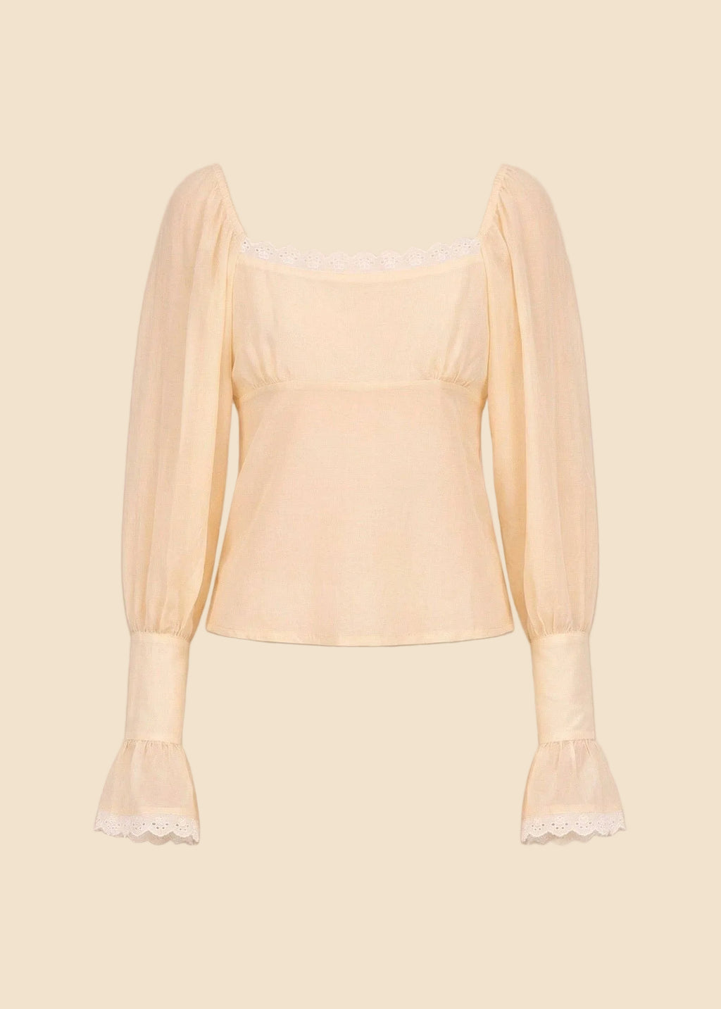 Light yellow blouse with sheer sleeves on a beige background