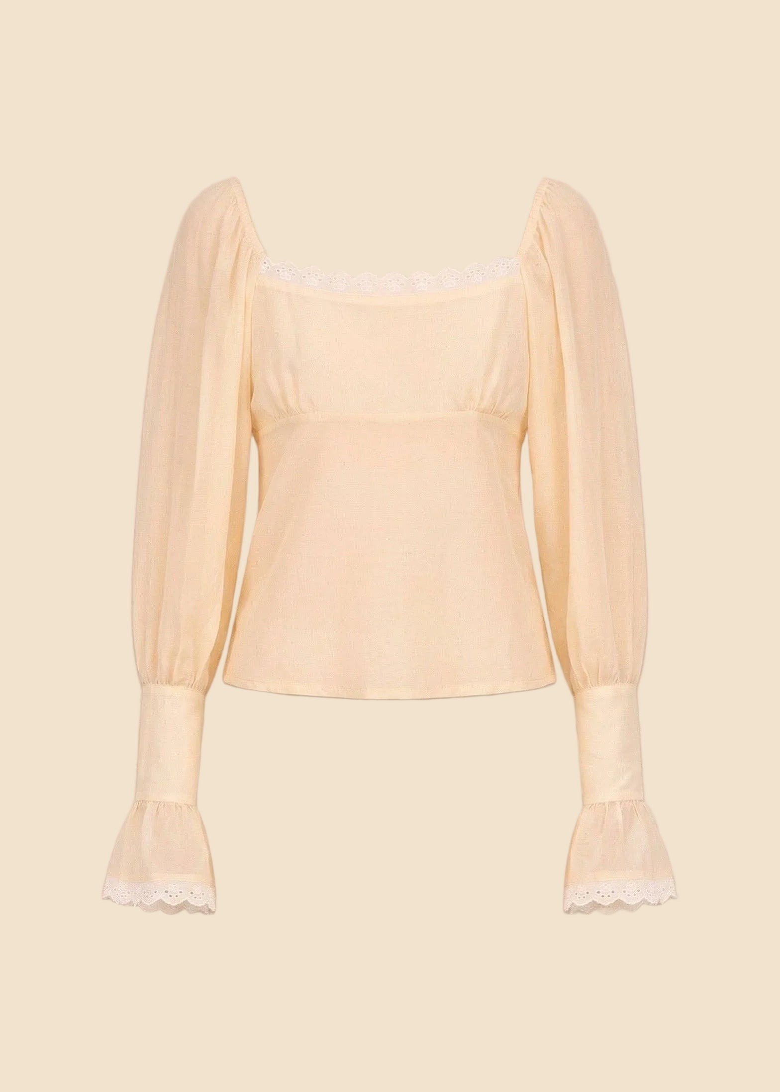 Light yellow blouse with sheer sleeves on a beige background