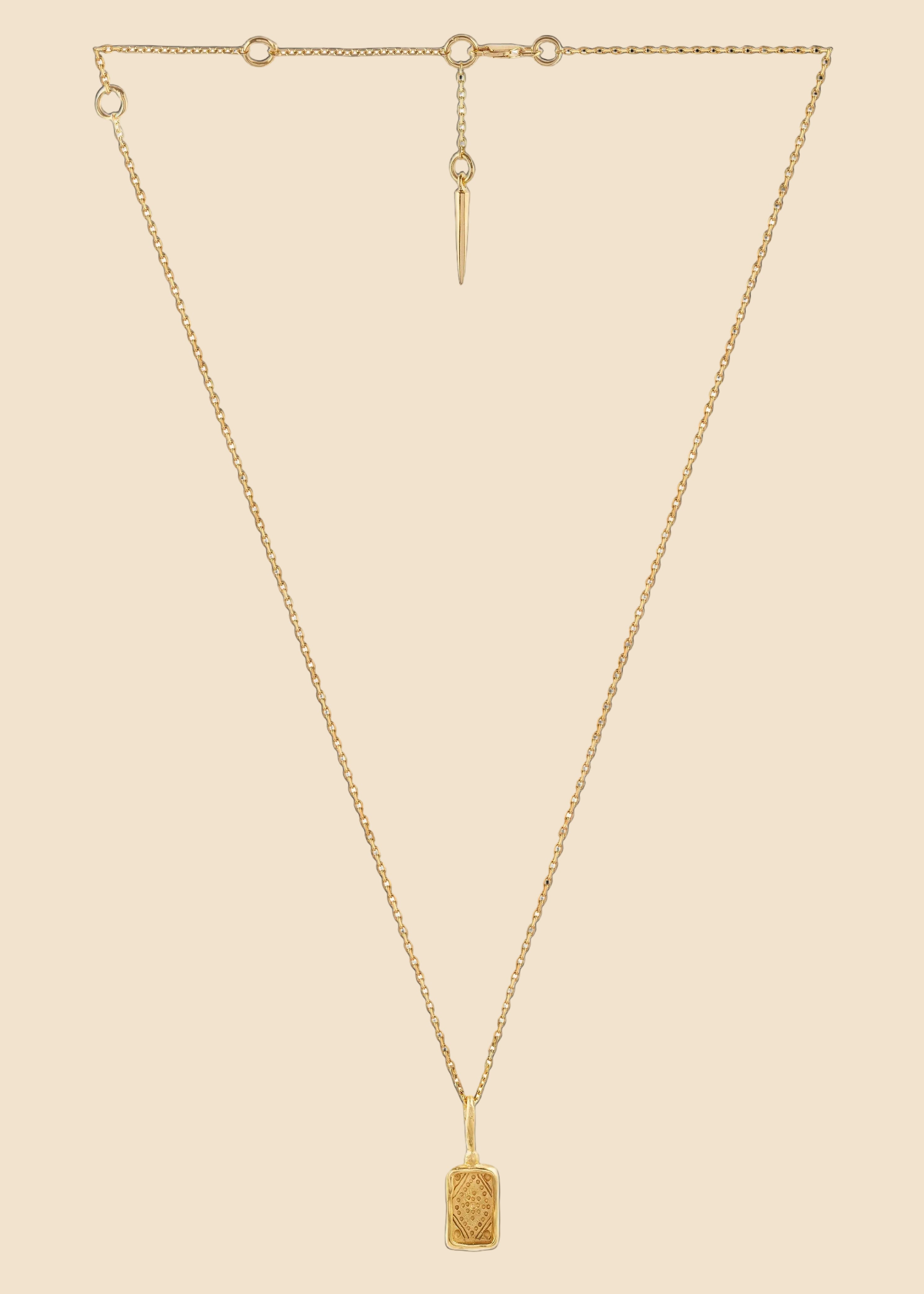 Gold necklace with a pendant on a white background