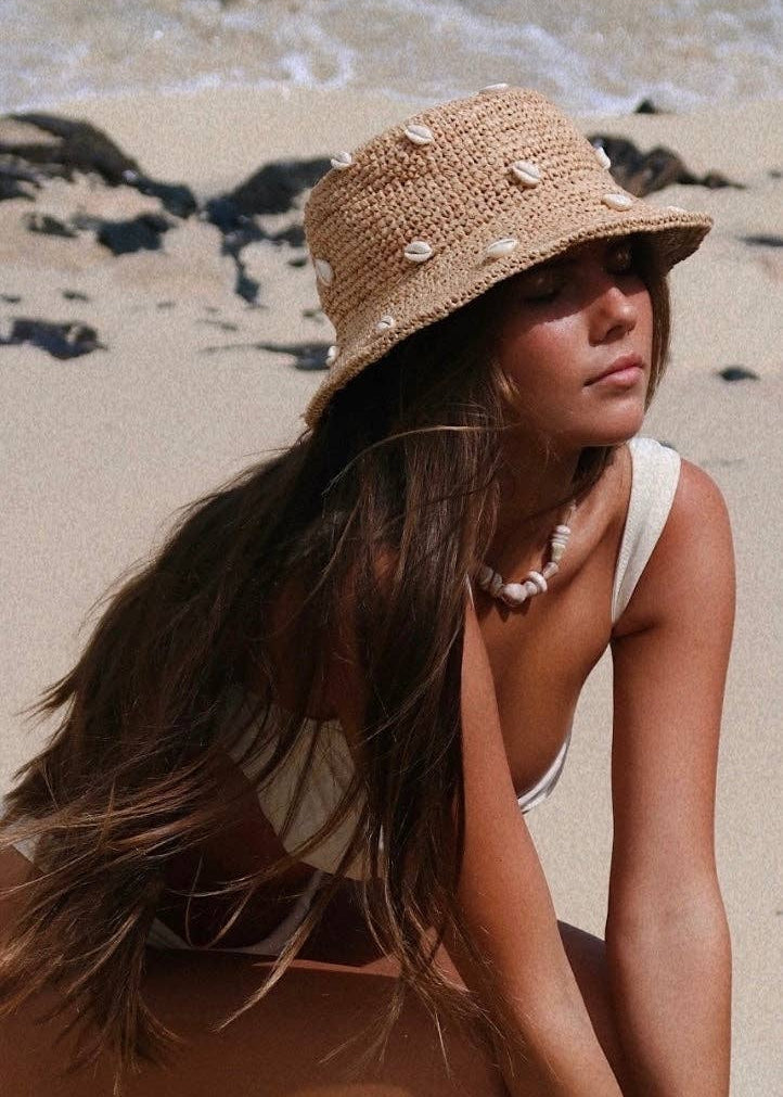 Woman wearing a straw hat on a beach