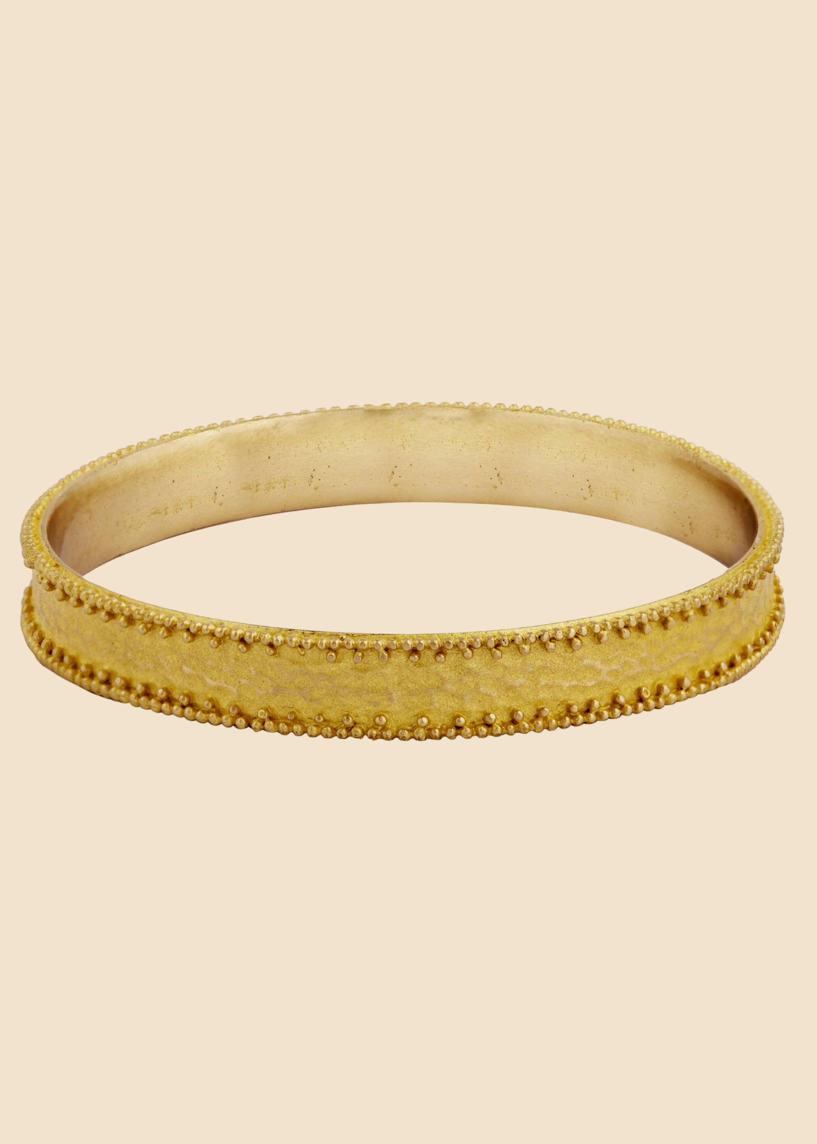 Gold bracelet on a white background