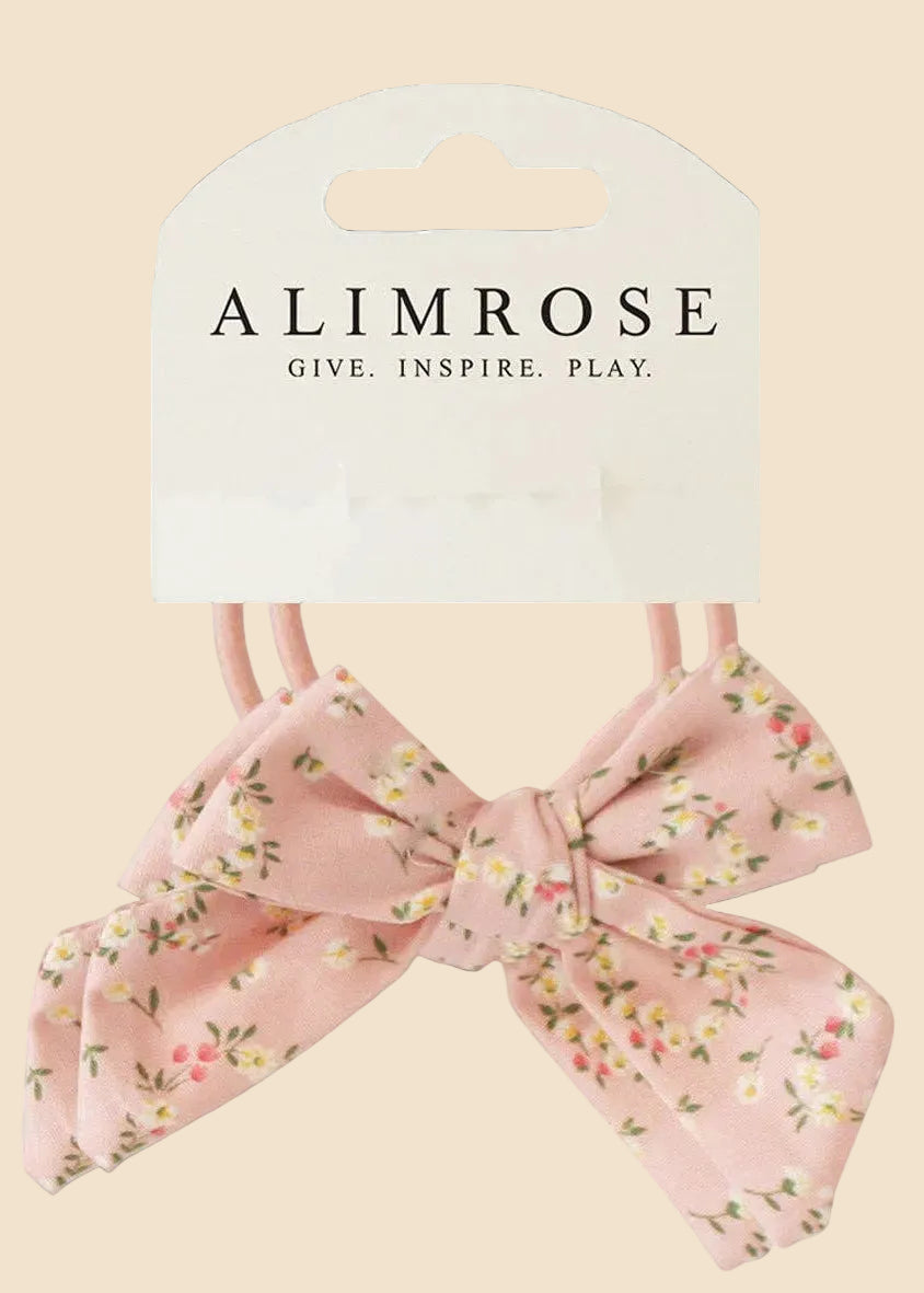 Pink floral hair bows with 'Alimrose' packaging on a white background