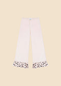 Pink pants with polka dot cuffs on a white background